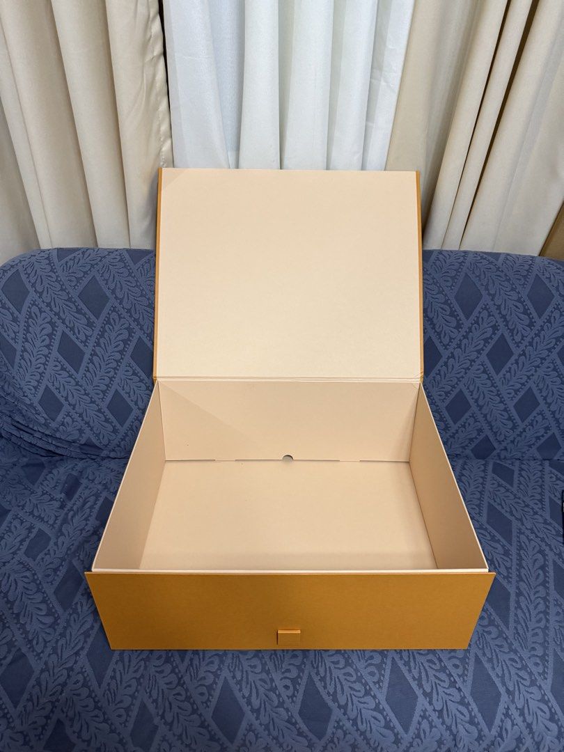 Authentic Louis Vuitton Large Gift Box (Category: Luxury Bags & Wallets) located in Manila. Submitted by lunacakes (Listing ID 1470646973, Image 2). Description: - Authentic Louis Vuitton large rigid box - Vibrant orange exterior with signature black block lettering - Secure magnetic front tab flap closure - Pristine, clean beige interior lining - Sturdy cardboard construction with clean edges - Ideal for luxury storage, organizing, or chic room 