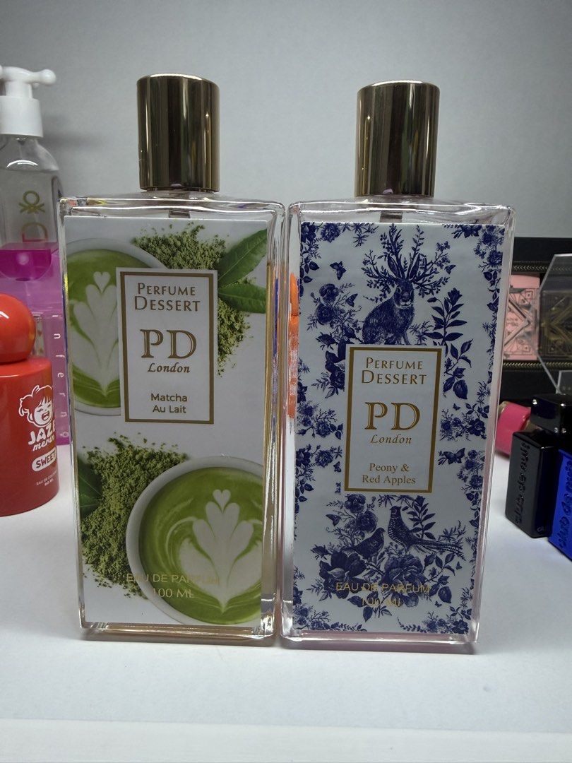 Authentic Perfume Dessert 700 for both (Category: Fragrance & Deodorants) located in Bulacan. Submitted by mangoloviiee (Listing ID 1470657914, Image 1). Description: - Brand: Perfume Dessert London - Type: Eau de Parfum (EDP) - Size: 100ml per bottle - Variant 1 (Left): Matcha Au Lait (yellow tint, almost full) - Variant 2 (Right): Peony & Red Apples (pink tint, about half full) - Includes: Original gold-colored caps - RFS: Decluttering, great w