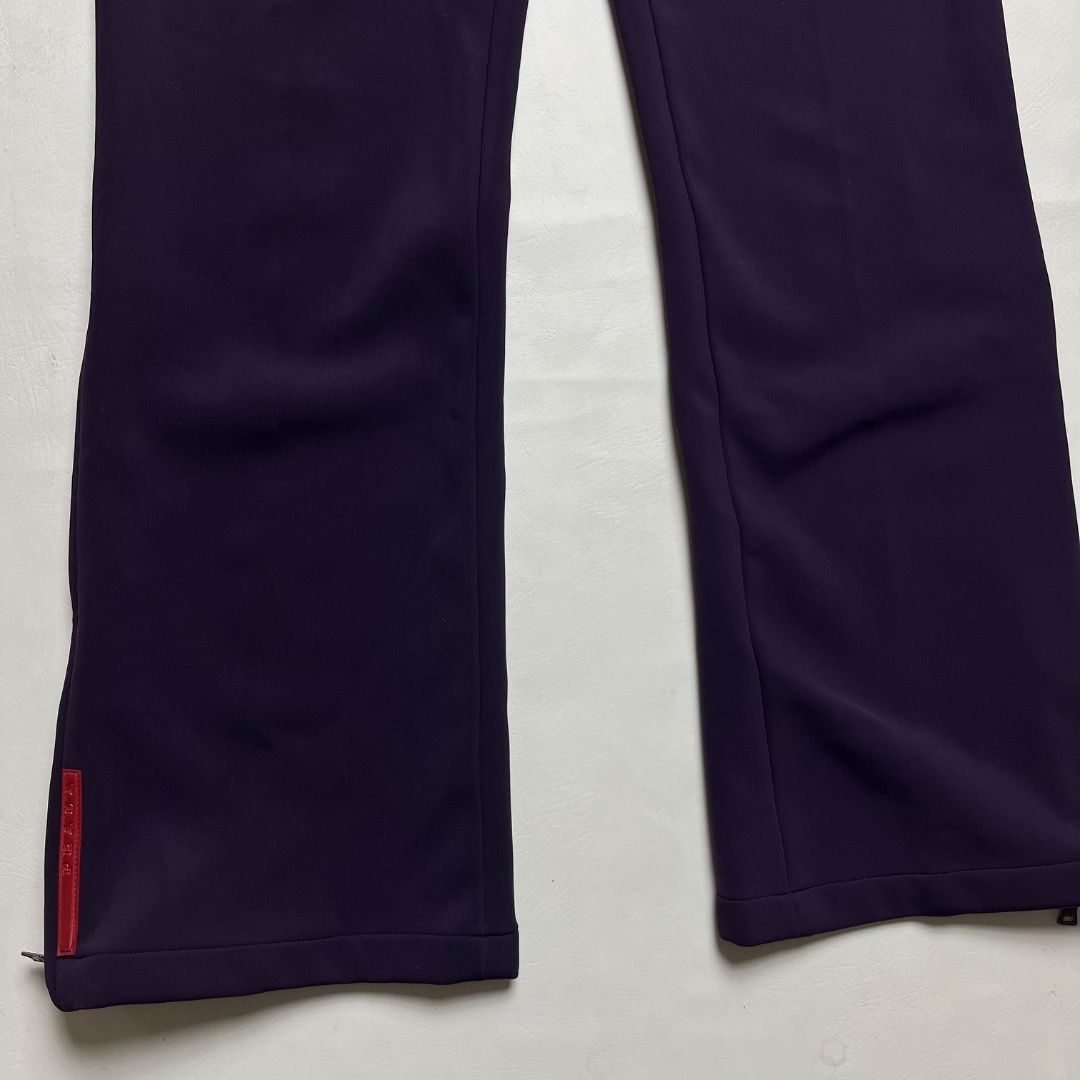 Authentic Prada Sport Technical Pants (Category: Joggers) located in Caloocan City. Submitted by achilles_grails (Listing ID 1470564345, Image 2). Description: - Brand: Prada Sport (Made in Italy) - Color: Deep purple - Fit: Straight leg with zipper hems - Details: Iconic red Prada logo tab near cuff, internal waist tag, and red inner piping - Material: Clean, structured fabric with slight stretch - Condition: Excellent vintage/archive piece - Id
