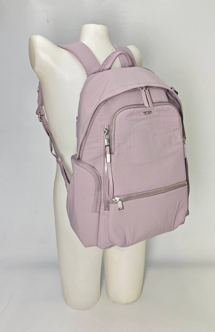 Authentic TUMI Voyageur Nylon Backpack Mauve - lilac (Category: Backpacks) located in Quezon City. Submitted by hollowwillow (Listing ID 1470616134, Image 3). Description: - Brand: Tumi - Color: Lilac purple with silver-tone hardware 14'h x 10.4'w x 5'd inches - Material: Durable, clean nylon exterior with light fabric-lined interior - Compartments: Wide-opening main compartment with interior zip and slip pockets - Storage: Multiple exterior zip 
