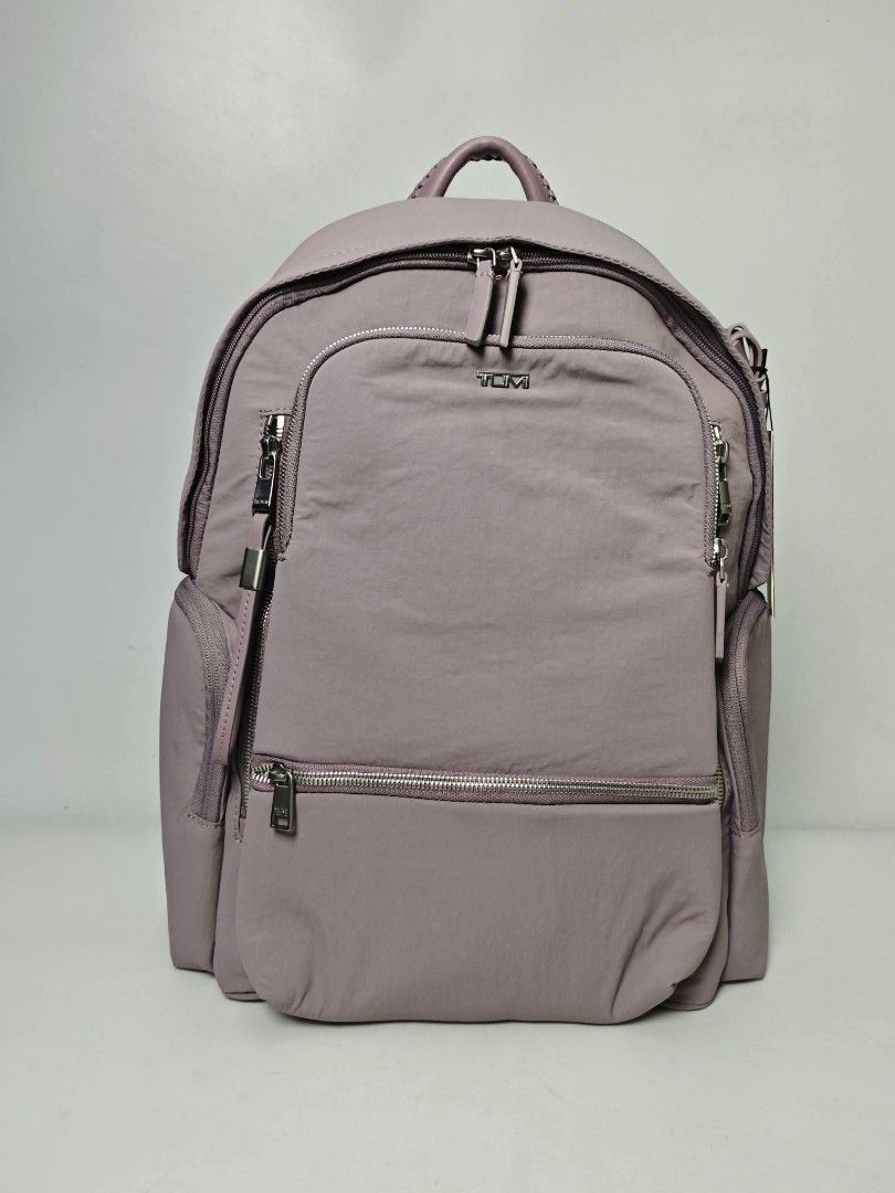 Authentic TUMI Voyageur Nylon Backpack Mauve - lilac (Category: Backpacks) located in Quezon City. Submitted by hollowwillow (Listing ID 1470616134, Image 1). Description: - Brand: Tumi - Color: Lilac purple with silver-tone hardware 14'h x 10.4'w x 5'd inches - Material: Durable, clean nylon exterior with light fabric-lined interior - Compartments: Wide-opening main compartment with interior zip and slip pockets - Storage: Multiple exterior zip 