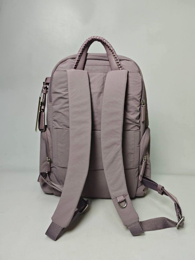Authentic TUMI Voyageur Nylon Backpack Mauve - lilac (Category: Backpacks) located in Quezon City. Submitted by hollowwillow (Listing ID 1470616134, Image 2). Description: - Brand: Tumi - Color: Lilac purple with silver-tone hardware 14'h x 10.4'w x 5'd inches - Material: Durable, clean nylon exterior with light fabric-lined interior - Compartments: Wide-opening main compartment with interior zip and slip pockets - Storage: Multiple exterior zip 