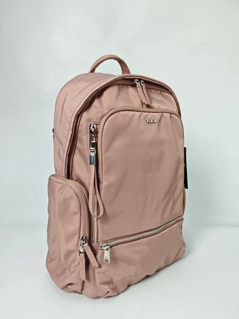 Authentic TUMI Voyageur Pink Nylon Backpack (Category: Backpacks) located in Quezon City. Submitted by hollowwillow (Listing ID 1470615933, Image 2). Description: - Brand: Tumi - Color: Pink/light mauve nylon with silver-tone hardware - Condition: Brand new with original hang tags attached - Storage: Multiple front and side zip compartments for easy organization - Interior: Light grey lining with extra pockets - Comfort: Top handle and adjustable