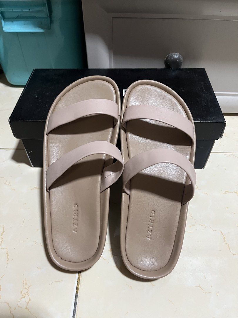 AZTRID Blake Sandals (Category: Flats & Sandals) located in Manila. Submitted by p1nkbaddi3 (Listing ID 1470659181, Image 1). Description: LAST PRICE POSTED Size US7 - Brand: AZTRID - Style: Double strap slide sandals - Color: beige - Design: Minimalist with two wide straps and comfortable molded footbed - Condition: Clean, minimal wear visible - Inclusions: Original black branded shoebox 💰Payment Method: Payment first via Gcash or bank transfer