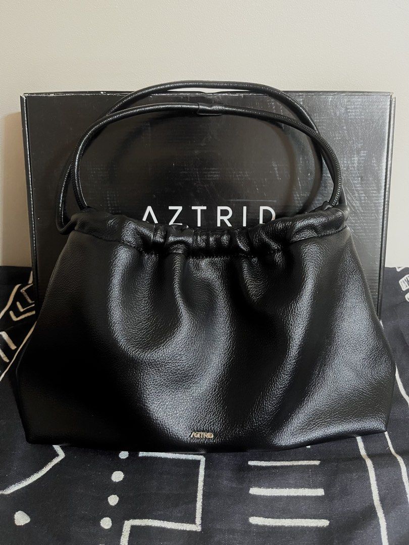 AZTRID Medium Dumpling Bag (Category: Shoulder Bags) located in Manila. Submitted by p1nkbaddi3 (Listing ID 1470655951, Image 1). Description: LAST PRICE POSTED. - Brand: AZTRID - Color: Classic Black - Design: Trendy ruched top opening with dual thin handles - Hardware: Metal brand logo plate near the bottom front - Interior: Fabric-lined with a convenient zip pocket - Packaging: Includes original box and dust bag - Condition: Excellent - Perfec