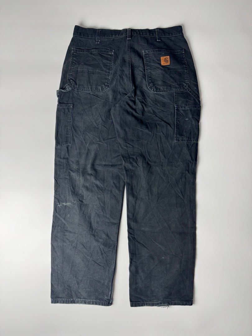 B11 BLK Carhartt Black Carpenter Work Pants (Category: Jeans) located in Cavite. Submitted by loadeadgears (Listing ID 1470687307, Image 2). Description: - Brand: Carhartt - Style: Classic utility canvas work pants with hammer loop and tool pockets - Color: Faded black with heavy natural distressing and a broken-in, soft feel - Waist: 17 inches across - Inseam: 32 inches - Leg Opening: 9 inches flat - Condition: Tough, durable, and ready for more