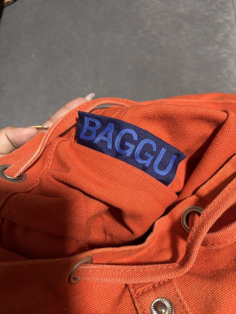 BAGGU Orange Canvas Backpack (Category: Backpacks) located in Manila. Submitted by alyanarein (Listing ID 1470724426, Image 3). Description: Bright orange BAGGU canvas backpack with a snap flap, drawstring closure, and front pocket. Clean and ready for daily use, school, or travel. Condi: 8/10.