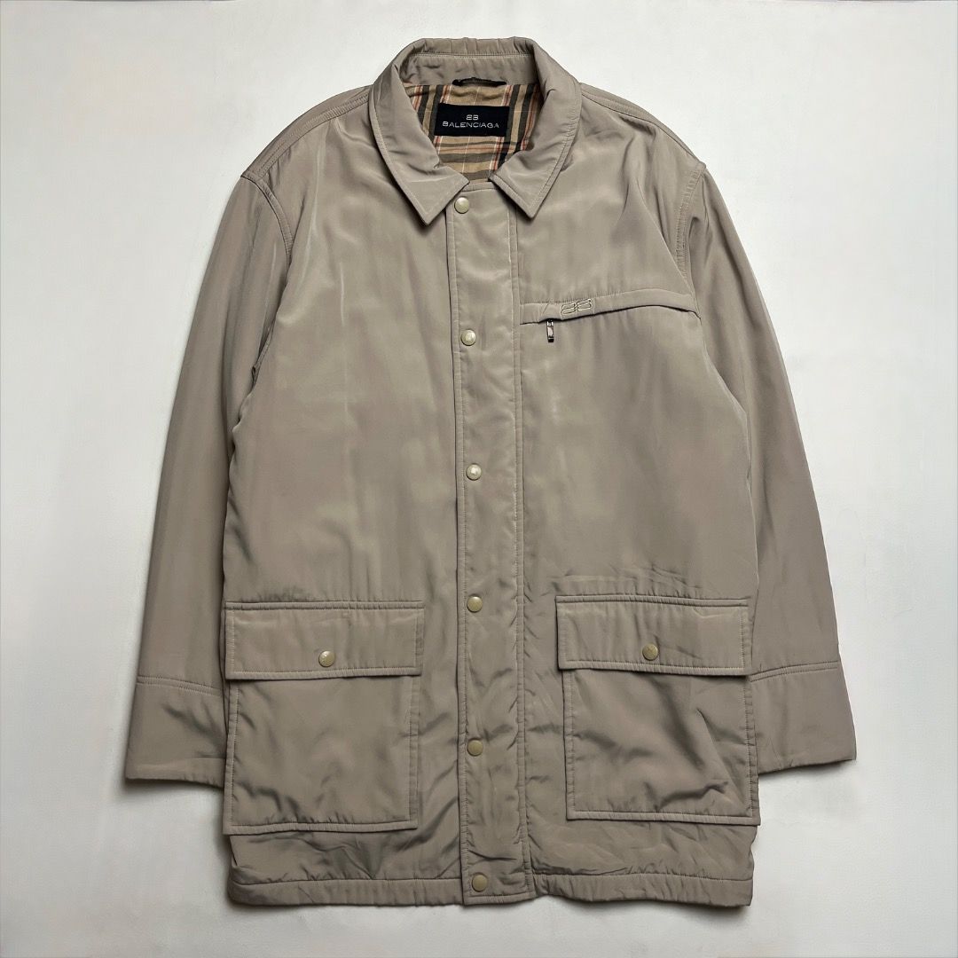 Balenciaga Beige Plaid Lined Button Jacket Size 4 (Category: Coats, Jackets and Outerwear) located in Caloocan City. Submitted by achilles_grails (Listing ID 1470584284, Image 1). Description: - Brand: Balenciaga - Color: Neutral beige with classic plaid inner lining - Size: 4 - Material: Polyester and polyurethane shell - Closure: Snap button front closure - Pockets: Two large lower flap pockets and one zippered chest pocket - Details: Embroider