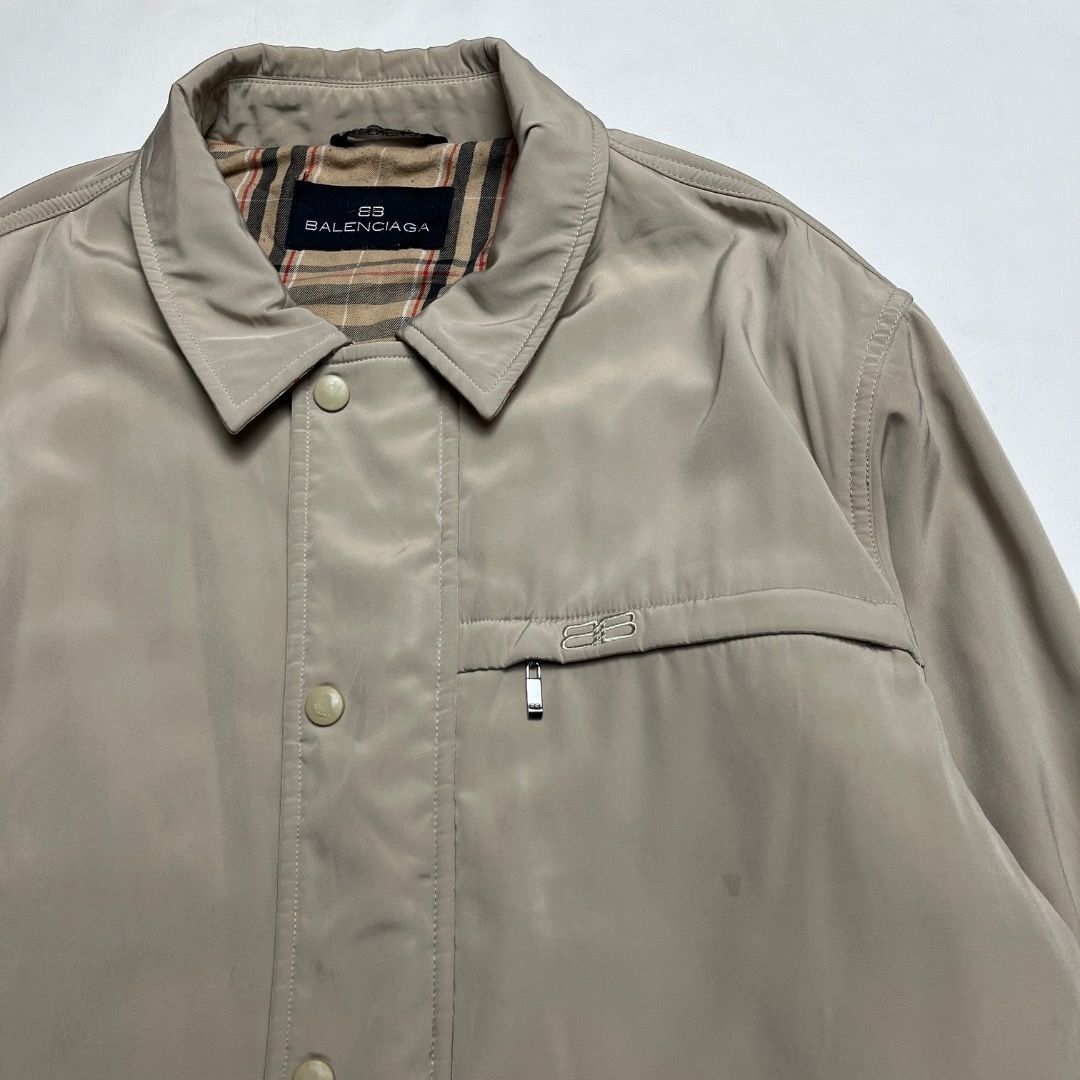 Balenciaga Beige Plaid Lined Button Jacket Size 4 (Category: Coats, Jackets and Outerwear) located in Caloocan City. Submitted by achilles_grails (Listing ID 1470584284, Image 2). Description: - Brand: Balenciaga - Color: Neutral beige with classic plaid inner lining - Size: 4 - Material: Polyester and polyurethane shell - Closure: Snap button front closure - Pockets: Two large lower flap pockets and one zippered chest pocket - Details: Embroider