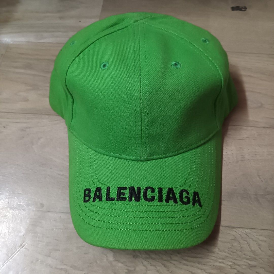 Balenciaga Neon Green Baseball Cap (Category: Caps & Hats) located in Manila. Submitted by itsnik444 (Listing ID 1470649070, Image 1). Description: - Brand: Balenciaga - Color: Bright green with black embroidered logo lettering on the brim - Material: 100% cotton, Made in China - Design: Classic six-panel construction with embroidered eyelets - Fit: Adjustable strap at the back for a customizable fit - Condition: Clean interior with original fabr