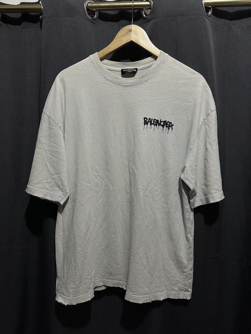 Balenciaga Unifit Drip Logo Distressed Tee (Category: Tshirts & Polo Shirts ) located in Buenavista. Submitted by themodernrack (Listing ID 1470591072, Image 1). Description: Condition: Good condition, minimal hairlines, needs wash on some parts (features intentional factory distressing/riips throughout collar and cuffs as part of the Unifit design) Measurements & Sizing: Size: Tagged Size XS (Oversized boxy fit, fits up to M/L) Width (Pit to Pit