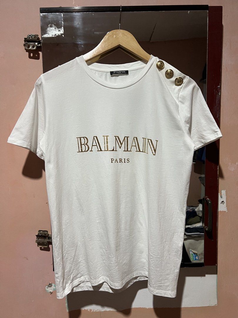 Balmain Gold button shirt (Category: Tshirts & Polo Shirts ) located in Sibulan. Submitted by rustysbestpick (Listing ID 1470665407, Image 1). Description: Balmain Gold button shirt Authentic Excellent condition Issue: ripped fabric on 1 gold button Washed & ready to wear Size 38 (fits small/medium) .