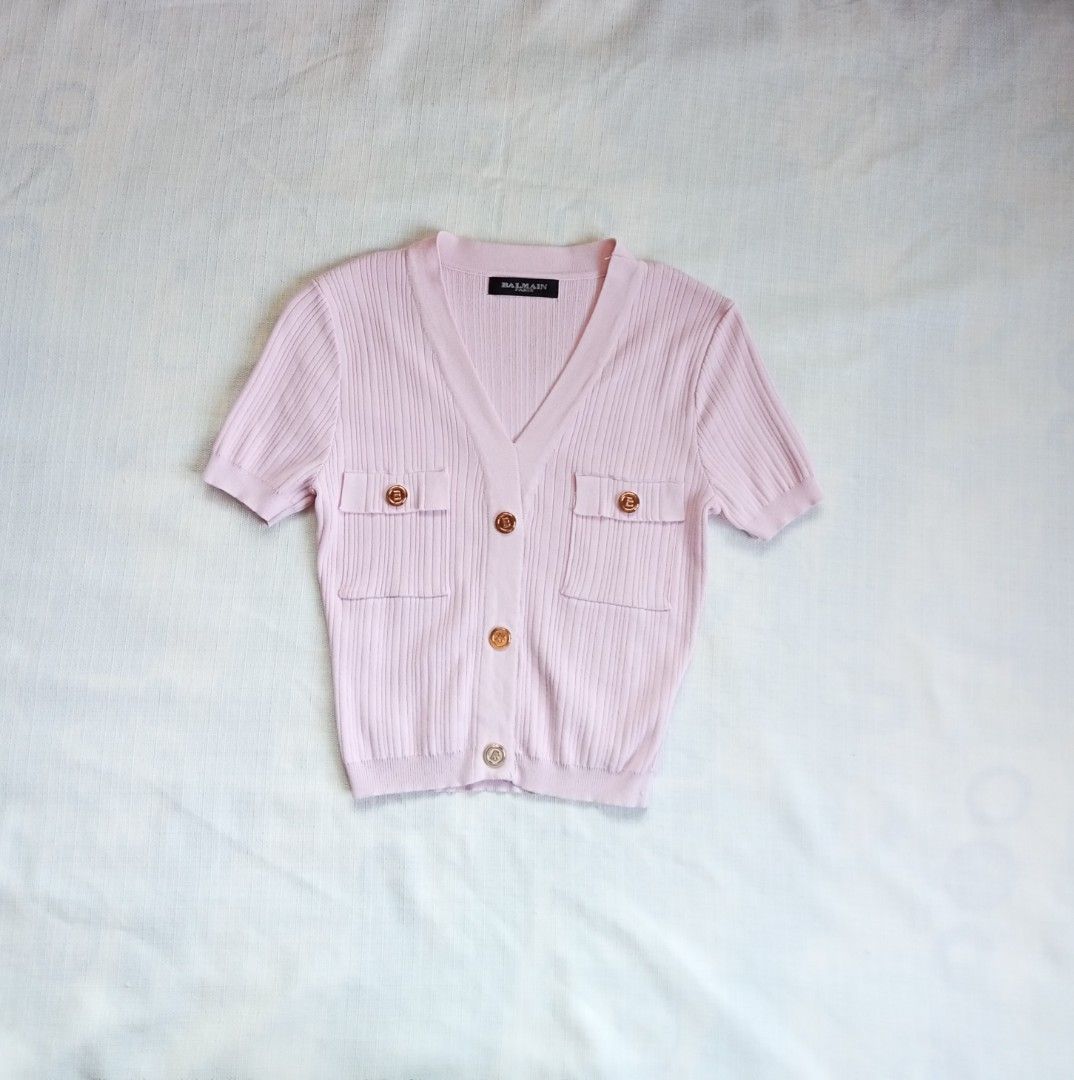 Balmain pink v neck knitted top (Category: Shirts) located in Bagabag. Submitted by thrift_stories96 (Listing ID 1470700473, Image 1). Description: Balmain pink v neck knitted top Small Length - 18 Width - 14 stretch up to 17 Condition - excellent No flaw.