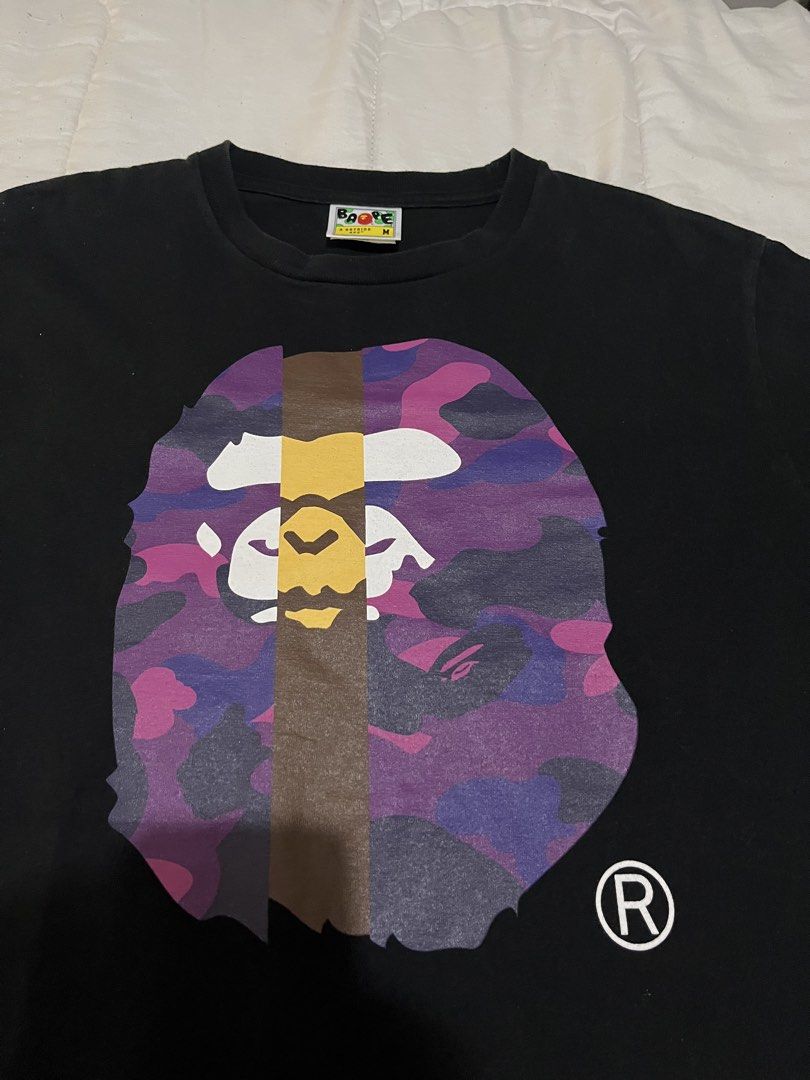 BAPE Purple Camo Ape Head (Category: Tshirts & Polo Shirts ) located in Manila. Submitted by westbridge007 (Listing ID 1470671930, Image 2). Description: BAPE Color Camo Ape Head T-Shirt – Black / Purple / Pink Price: ₱2,500 Size: Medium (M) Condition: Used but in very good condition Selling my black BAPE graphic T-shirt featuring the purple and pink camo Ape Head design * Color: Black / Purple / Pink * Size: M * Brand: A Bathing Ape (BAPE) * Cla
