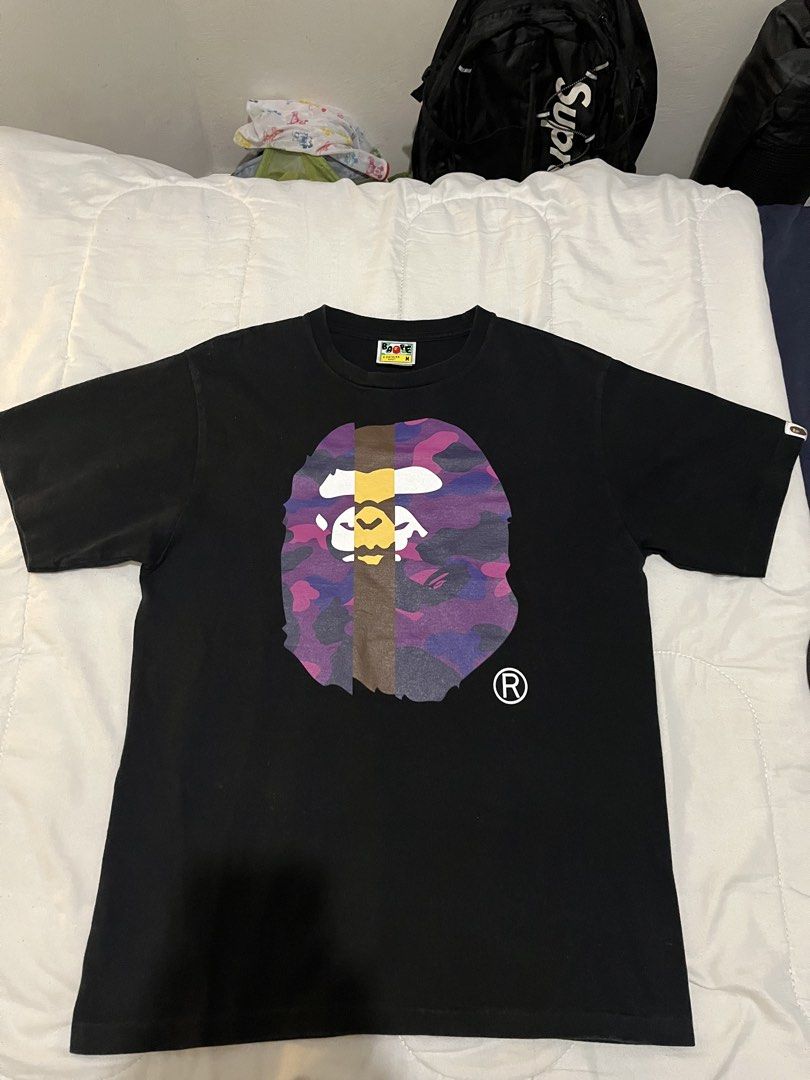 BAPE Purple Camo Ape Head (Category: Tshirts & Polo Shirts ) located in Manila. Submitted by westbridge007 (Listing ID 1470671930, Image 1). Description: BAPE Color Camo Ape Head T-Shirt – Black / Purple / Pink Price: ₱2,500 Size: Medium (M) Condition: Used but in very good condition Selling my black BAPE graphic T-shirt featuring the purple and pink camo Ape Head design * Color: Black / Purple / Pink * Size: M * Brand: A Bathing Ape (BAPE) * Cla