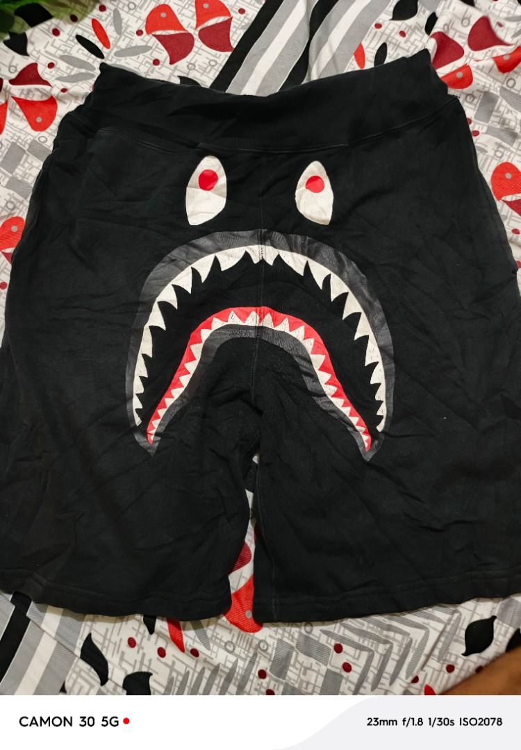 BAPE Shark Face Black Sweat Shorts (Category: Shorts) located in San Jose. Submitted by jerickimbi66675 (Listing ID 1470713158, Image 1). Description: - 30-38 x 21 x 11 - Color rate : 9 - Issue : Hairlines - Brand: BAPE - Color: Black - Design: Iconic big shark face graphic across the front with eye and teeth details - Material: Thick, premium cotton for maximum comfort - Waist: Comfortable elastic waistband.