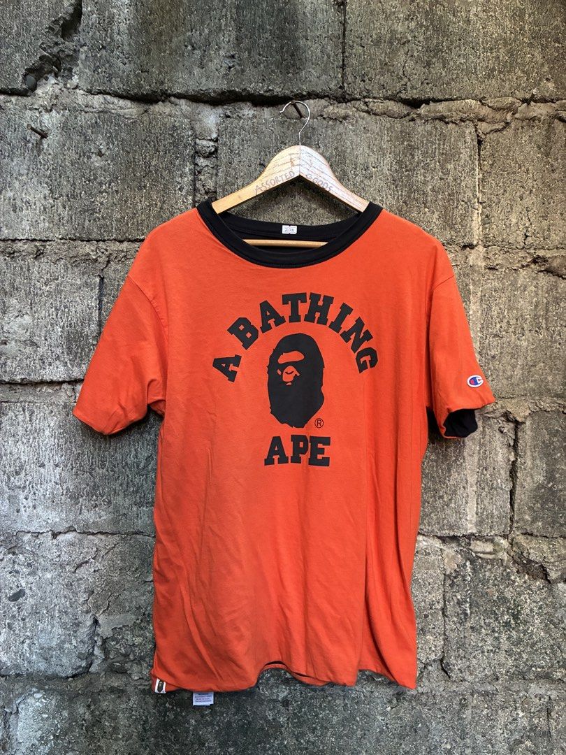 BAPE x Champion Reversible Tee Orange Black Medium (Category: Tshirts & Polo Shirts ) located in Manila. Submitted by assortedgoodsv3 (Listing ID 1470621271, Image 2). Description: - Brand: BAPE x Champion - Style: Reversible T-Shirt (Two looks in one!) - Color/Design: Black side with large ape head graphic / Orange side with text and smaller ape head graphic - Details: Iconic Champion logo patch on the sleeve - Size: Medium - Origin: Made in USA