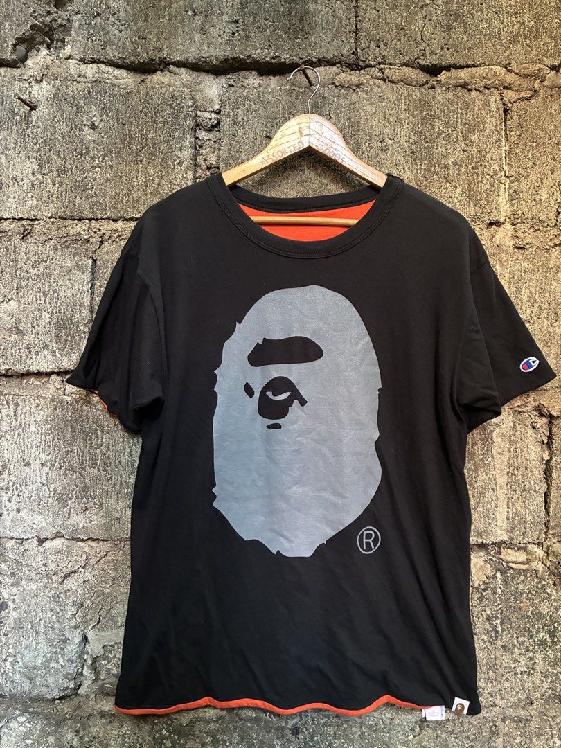 BAPE x Champion Reversible Tee Orange Black Medium (Category: Tshirts & Polo Shirts ) located in Manila. Submitted by assortedgoodsv3 (Listing ID 1470621271, Image 1). Description: - Brand: BAPE x Champion - Style: Reversible T-Shirt (Two looks in one!) - Color/Design: Black side with large ape head graphic / Orange side with text and smaller ape head graphic - Details: Iconic Champion logo patch on the sleeve - Size: Medium - Origin: Made in USA