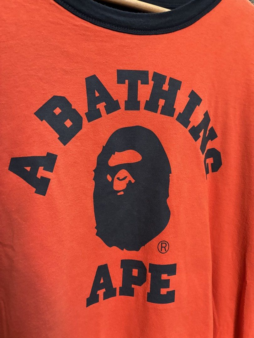 BAPE x Champion Reversible Tee Orange Black Medium (Category: Tshirts & Polo Shirts ) located in Manila. Submitted by assortedgoodsv3 (Listing ID 1470621271, Image 3). Description: - Brand: BAPE x Champion - Style: Reversible T-Shirt (Two looks in one!) - Color/Design: Black side with large ape head graphic / Orange side with text and smaller ape head graphic - Details: Iconic Champion logo patch on the sleeve - Size: Medium - Origin: Made in USA