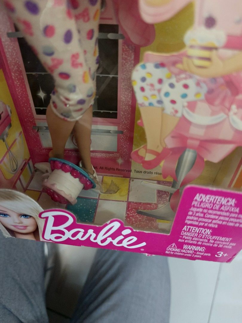 Barbie I Can Be Sweet Chef Doll (Category: Kids Toys) located in Davao. Submitted by chenny._chin968 (Listing ID 1470603528, Image 2). Description: - Barbie I Can Be Sweet Chef doll in original packaging - Features blonde hair, yellow chef hat, pink/white chef jacket, ruffled apron, and polka dot leggings - Includes a miniature cake accessory inside the box - Box has heavy shelf wear, creasing, and a taped top flap - Perfect for Barbie collectors