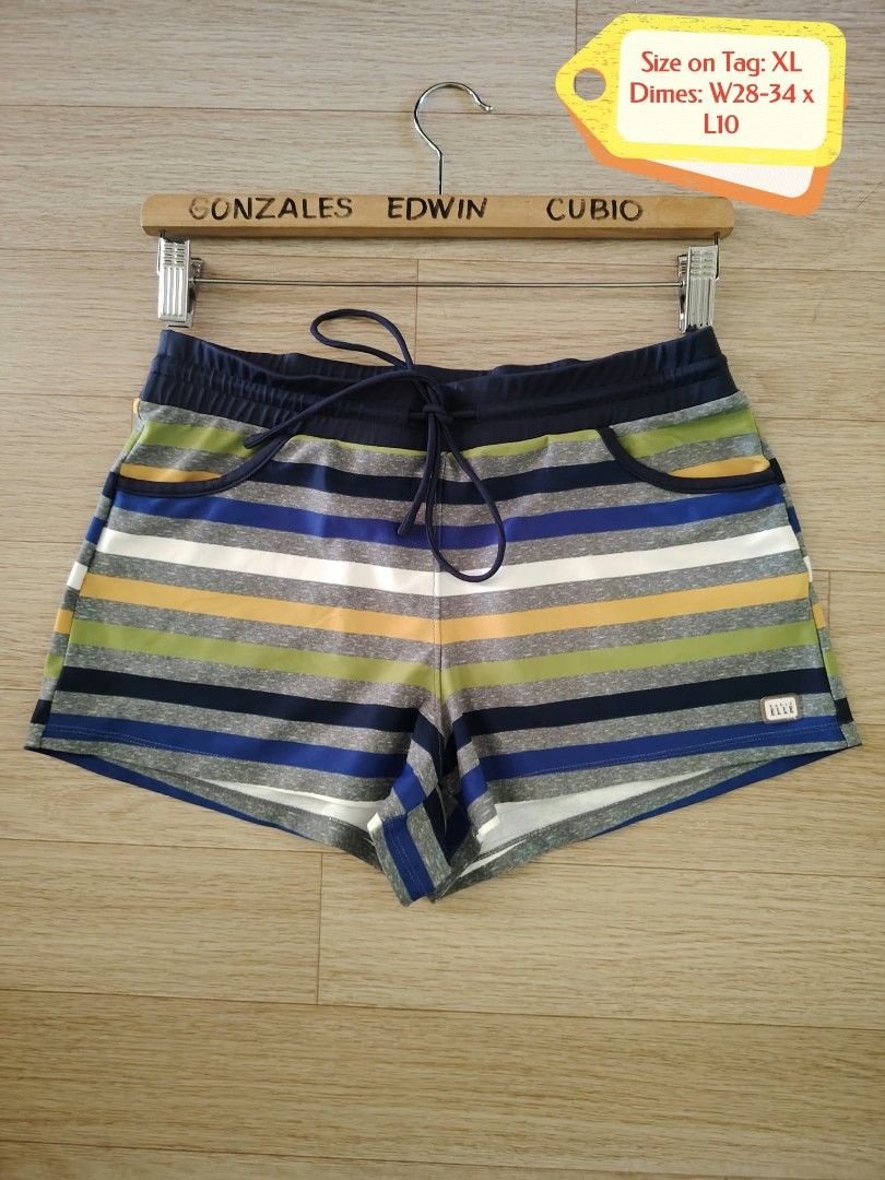 Basic Elle Striped Drawstring Athletic Shorts Size XL (Category: Shorts) located in Nasipit. Submitted by edwingonzales498-69377 (Listing ID 1470615696, Image 2). Description: - Brand: Basic Elle - Size: XL (Waist: 28-34 inches, Length: 10 inches) - Material: 80% polyester, 20% polyurethane - Design: Multi-colored horizontal stripes (navy blue, green, yellow, grey, white) - Features: Elastic waistband with adjustable drawstring, two front hand po