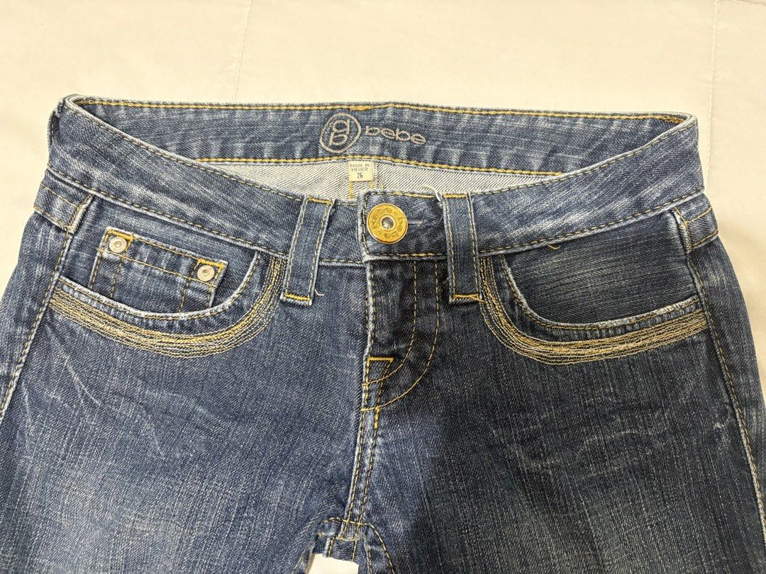 Bebe Blue Denim Jeans Size 26 (Category: Jeans) located in Manila. Submitted by nykji96 (Listing ID 1470567175, Image 3). Description: - Brand: Bebe - Wash: Medium blue - Fit: Low rise with bootcut legs - Details: Contrast stitching on front/back pockets - Special Feature: Signature round bling logo hardware on the back right pocket - Size: Tagged waist 26 - Origin: Made in Mexico - Condition: Excellent pre-loved condition (or brand new, ready to