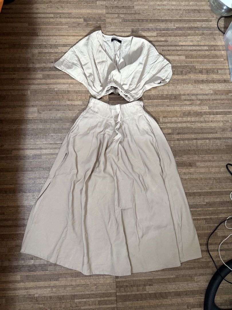 Beige Coordinates (Category: Sets or Coordinates) located in Manila. Submitted by razielaninon.bird (Listing ID 1470603990, Image 1). Description: - Brand: Woman Career - Style: Matching two-piece coordinate set (crop top and midi skirt) - Color: Neutral beige / cream - Size: M (tag attached) - Details: Short sleeve V-neck crop top with elasticized hem and pleated midi skirt with comfortable elastic waistband - Condition: Great, ready to wear - P