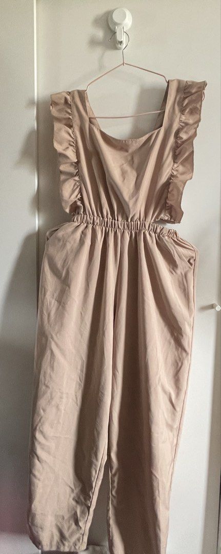 Beige sleeveless ruffled romper overalls (Category: Dresses) located in Agdangan. Submitted by happyphoenix.d92869 (Listing ID 1469213655, Image 3). Description: Issue: natastas portion sa waist. Would have kept it if marunong ako mag mend 🥹 - Color: Beige - Style: Sleeveless romper with square neckline and ruffled shoulder straps - Fit: Gathered waist detail for a flattering silhouette - Fabric: Light and comfortable, great for casual wear or d
