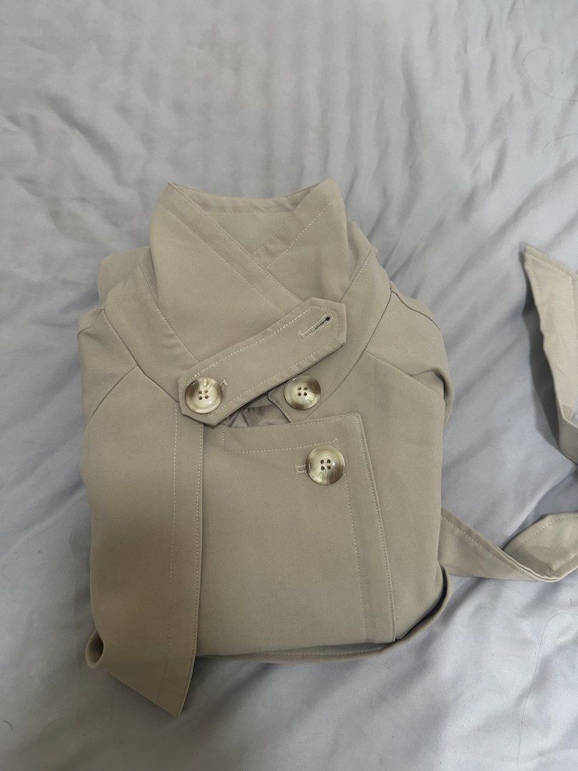 Beige trench coat (Category: Coats, Jackets and Outerwear) located in Pasig City. Submitted by shopmystuff.p (Listing ID 1470740786, Image 2). Description: Good as new Used once for my AU trip Can fit small to medium.