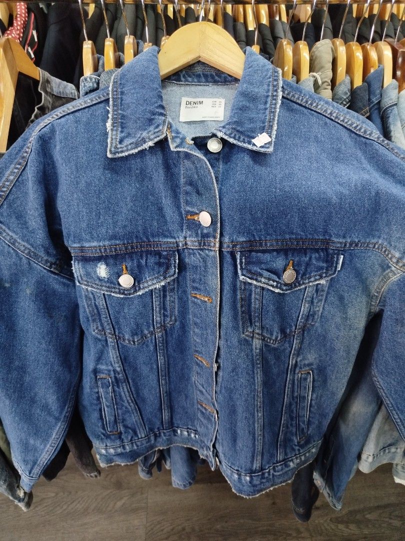 Bershka Denim Jacket Size XS (Category: Coats, Jackets and Outerwear) located in Quezon City. Submitted by epoquebyjaz (Listing ID 1470639611, Image 2). Description: - Brand: Bershka - Style: Casual oversized denim jacket - Color/Wash: Dark blue wash - Size: XS (Made in Bangladesh) - Details: Button-up front with metal hardware - Pockets: Two chest flap pockets and two side welt pockets - Edge: Trendy raw frayed hem and collar.
