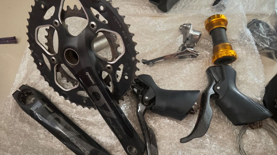 Bicycle components bundle with crankset handlebars and derailleurs (Category: Bicycles) located in Manila. Submitted by lonegamerxgoodfinds (Listing ID 1470580387, Image 2). Description: - Bike parts bundle: perfect for build projects or spares - Crankset, drop handlebars, and shift levers included - Front and rear derailleurs included - Bottom bracket, cassette, and seatpost included - Inner tube and mini pump included - Selling as a complete se