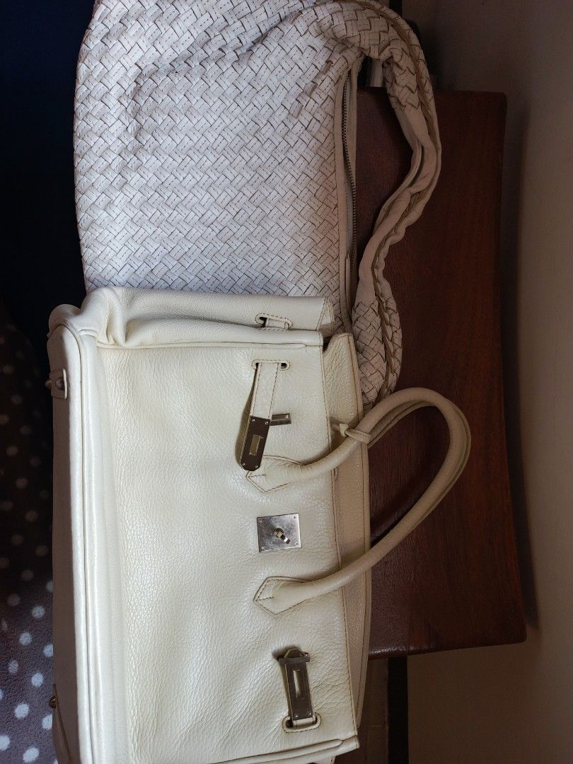 Birkin White Leather Handbag (Category: Luxury Bags & Wallets) located in Marikina City. Submitted by wisebuytoo (Listing ID 1470594574, Image 1). Description: With FREE one woven Handbag - Color & Material: Cream white grained leather - Hardware: Silver-tone with minor wear - Closure: Classic front turn-lock - Handles: Double top handles for easy carry - Interior: Lined with a zipper pocket and signature 'H' zipper pull - Protection: Metal feet 