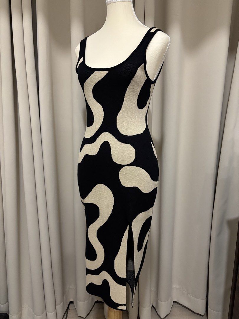 Black and Beige Abstract Pattern Sleeveless Midi Dress (Category: Dresses) located in Makati City. Submitted by shopmycloset.ray (Listing ID 1470704012, Image 2). Description: - Color/Pattern: Black and white abstract swirl - Style: Bodycon knit midi dress with scoop neckline and thick straps - Fit: Stretchy fabric that hugs your curves - Features: Side slit at the bottom hem for easy movement - Occasion: Perfect for nights out or casual weekend 