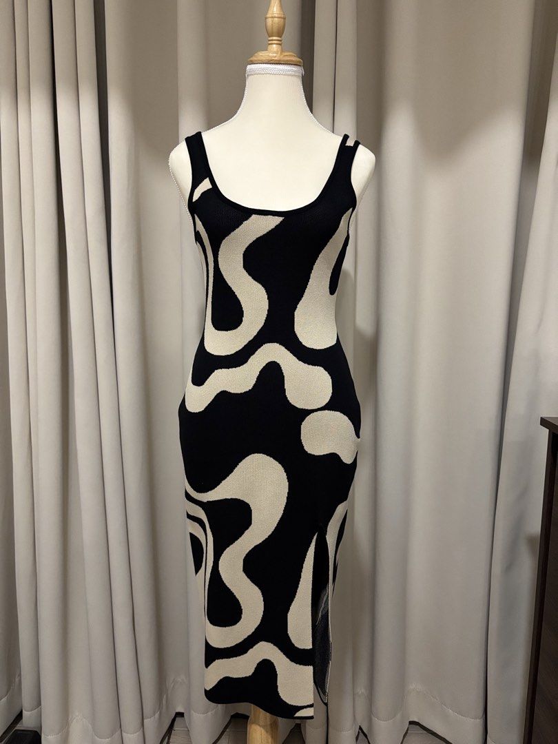 Black and Beige Abstract Pattern Sleeveless Midi Dress (Category: Dresses) located in Makati City. Submitted by shopmycloset.ray (Listing ID 1470704012, Image 1). Description: - Color/Pattern: Black and white abstract swirl - Style: Bodycon knit midi dress with scoop neckline and thick straps - Fit: Stretchy fabric that hugs your curves - Features: Side slit at the bottom hem for easy movement - Occasion: Perfect for nights out or casual weekend 