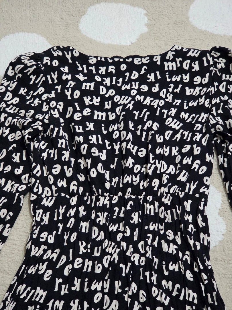 Mango Black and white letters mini dress (Category: Dresses) located in Marikina City. Submitted by dclicious2.0 (Listing ID 1470664224, Image 3). Description: Mango "Kaia" Letter Print Mini Dress • Design: Features an all-over typographic alphabet/letter print in a monochrome black and white colorway. • Silhouette: Tailored with a flattering V-neckline, long puffed/balloon sleeves, and an elastic pleated waist detail providing a fit-and-flare lo