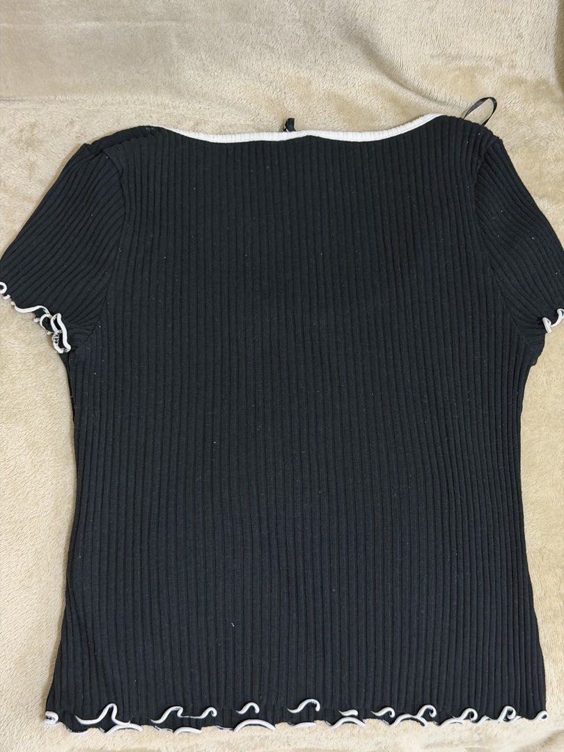 Black and White Ribbed Tee with Bow Detail (Category: Shirts) located in Manila. Submitted by xoxorml (Listing ID 1470699353, Image 2). Description: Black ribbed short-sleeve top with white contrast trim along the square neckline and cuffs. Features a cute little white bow right at the center of the chest. Lettuce hem finish at the bottom and sleeves. Stretchy fabric, super comfortable fit. RFS: Decluttering .