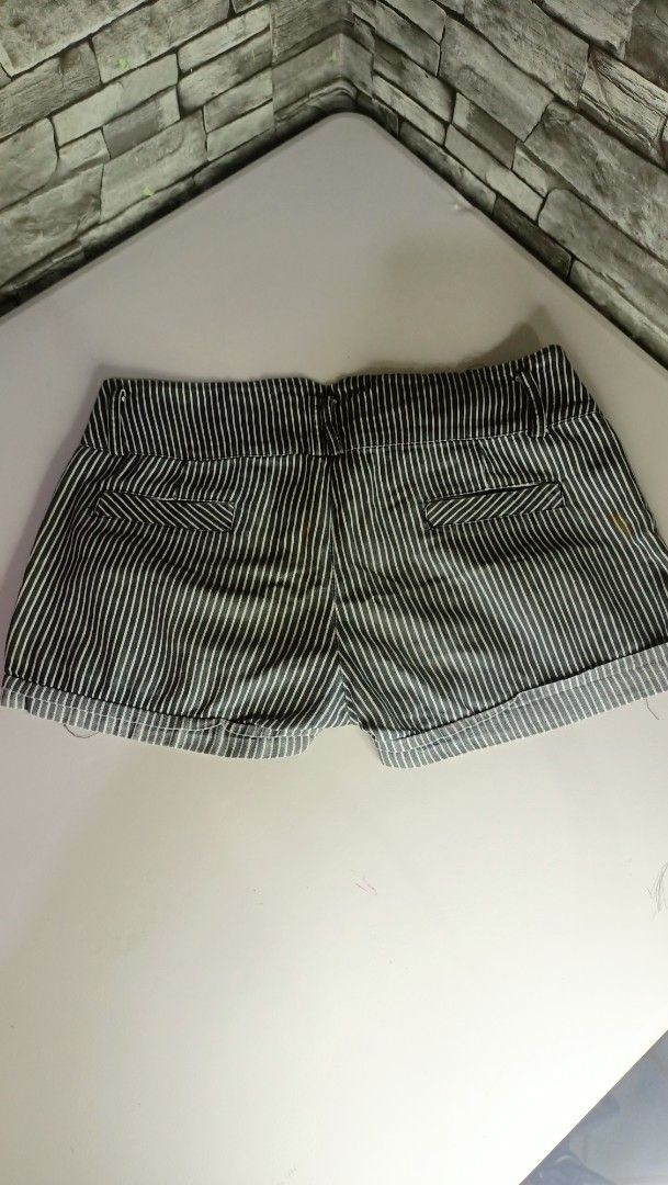 Black and White Striped Rolled Cuff Shorts (Category: Shorts) located in Antipolo. Submitted by reahespiritu (Listing ID 1470619458, Image 2). Description: - Color/Pattern: Black and white vertical pinstripes - Fit: Mid-rise with double button closure and zippered fly - Pockets: Front slant pockets and faux back welt pockets - Details: Stylish folded cuff hems at the bottom - Condition: Excellent, ready to wear.