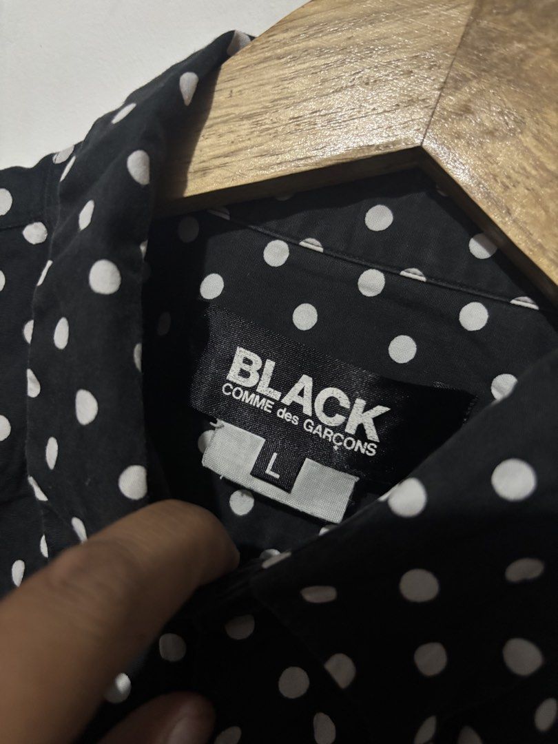 BLACK Comme des Garcons Polka Dot Button-Up Shirt Size L (Category: Shirts) located in Subic. Submitted by thriftpoison (Listing ID 1470655227, Image 3). Description: - Brand/Era: AD2008 Japanese designer piece - Design: Black with all-over white polka dots, classic collar, and single chest pocket - Material: 100% premium cotton, Made in Japan - Size: Tagged L - Length 28 Width 20 - Condition: Clean overall shape, great staple item.