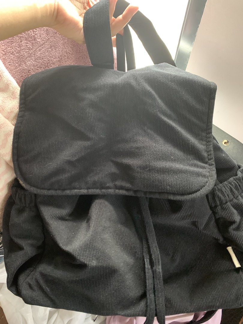 Black Corduroy Backpack with Flap and Drawstring (Category: Backpacks) located in Manila. Submitted by luckybird-488263 (Listing ID 1470693345, Image 1). Description: - Material: Trendy black corduroy - Closure: Flap top with secure drawstring underneath - Fit: Comfortable, adjustable shoulder straps - Storage: Roomy interior for everyday essentials - Style: Simple, minimalist design - Best for: Daily use, school, and weekend trips.