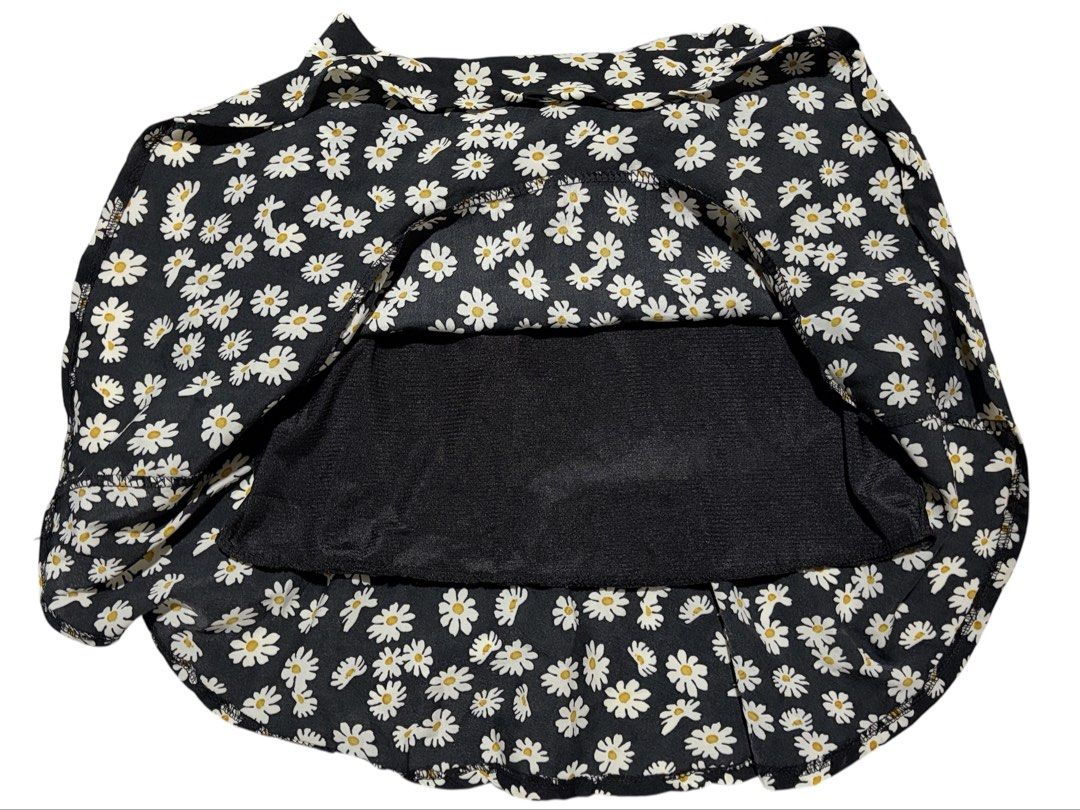 Black Daisy Print Ruffle Hem Mini Skirt (Category: Skirts) located in Cavite. Submitted by grandearth.39df3f (Listing ID 1470677673, Image 3). Description: - Style: Black mini skirt with all-over white daisy print - Fit: Comfortable elastic waistband and flared ruffle hem - Coverage: Built-in black inner lining shorts underneath - Material: Lightweight and breathable fabric - Vibe: Cute, casual, and easy to style.