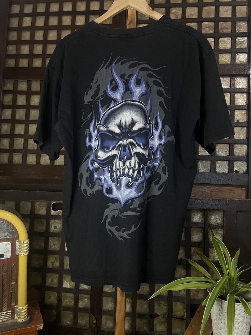 Black Graphic Tee Skull Flame Design (Category: Tshirts & Polo Shirts ) located in Nampicuan. Submitted by aireann_10 (Listing ID 1470680678, Image 2). Description: - Color: Black - Fit: Relaxed fit with crew neckline - Design: Bold blue and grey flame skull graphic on front and large matching graphic with subtle dragon details on the back - Style: Classic Y2K rocker and streetwear.