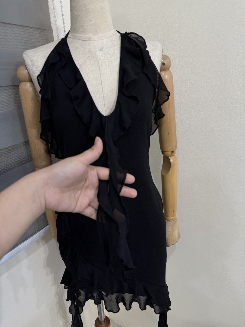 Black Halter Ruffle Mini Dress (Category: Dresses) located in Antipolo. Submitted by jackiestash2 (Listing ID 1470644626, Image 2). Description: - Color: Black - Style: Bodycon, sleeveless mini dress - Neckline: Halter neck tie with deep V-neck and ruffle trim - Details: Ruffle trim down the center front, sheer mesh hem, and hanging side ribbons - Fit: Form-fitting and short length - Perfect for: Night outs, parties, and clubbing Antipolo Gcash/B