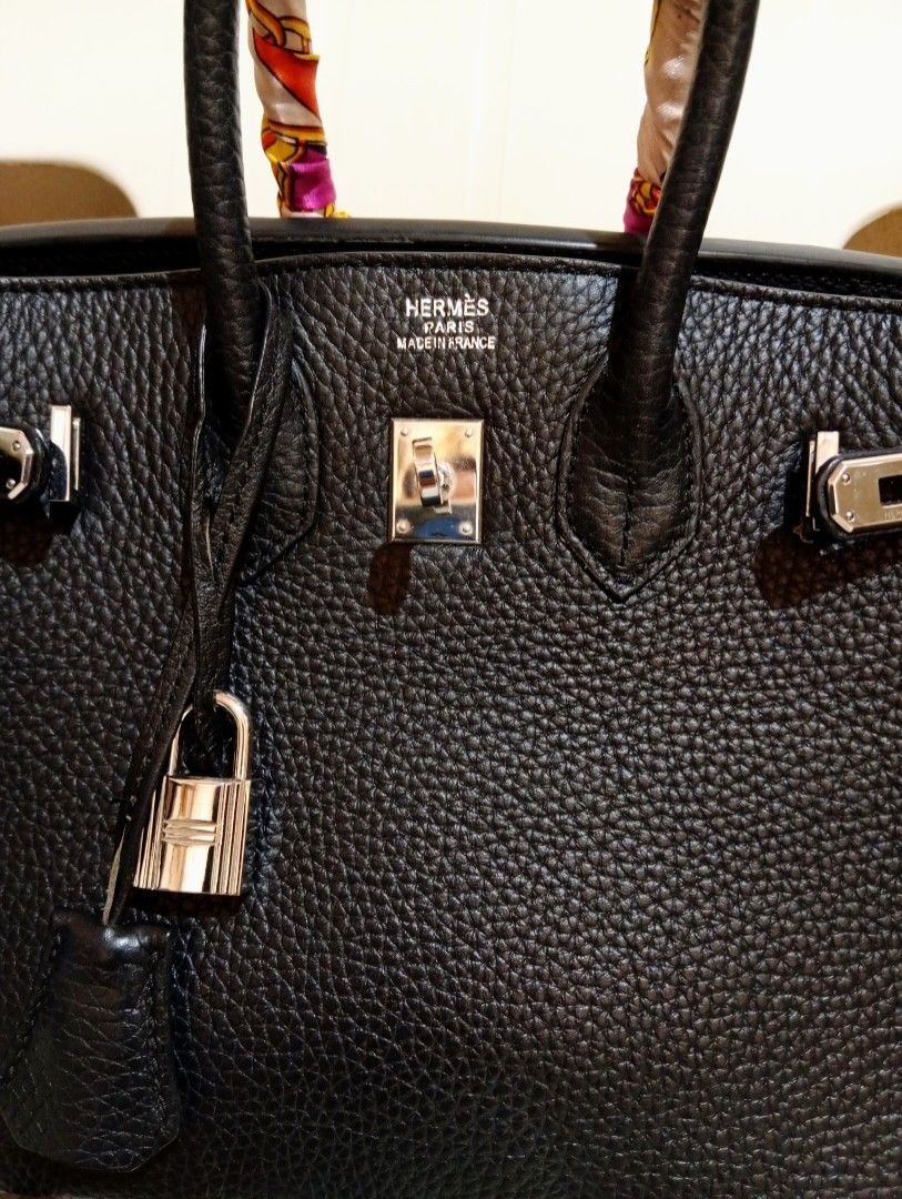 Black Leather Handbag with Twilly Scarf (Category: Tote Bags) located in Cebu City. Submitted by champagnescloset (Listing ID 1470406948, Image 1). Description: - Material: Premium black pebble leather with silver hardware - Inclusions: Includes lock, keys, and clochette - Design: Structured tote with side gussets and top handles - Unique feature: One handle is styled with a colorful patterned twilly scarf - Condition: Well-maintained exterior sh
