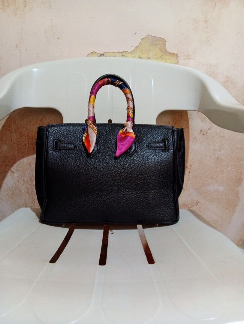 Black Leather Handbag with Twilly Scarf (Category: Tote Bags) located in Cebu City. Submitted by champagnescloset (Listing ID 1470406948, Image 2). Description: - Material: Premium black pebble leather with silver hardware - Inclusions: Includes lock, keys, and clochette - Design: Structured tote with side gussets and top handles - Unique feature: One handle is styled with a colorful patterned twilly scarf - Condition: Well-maintained exterior sh