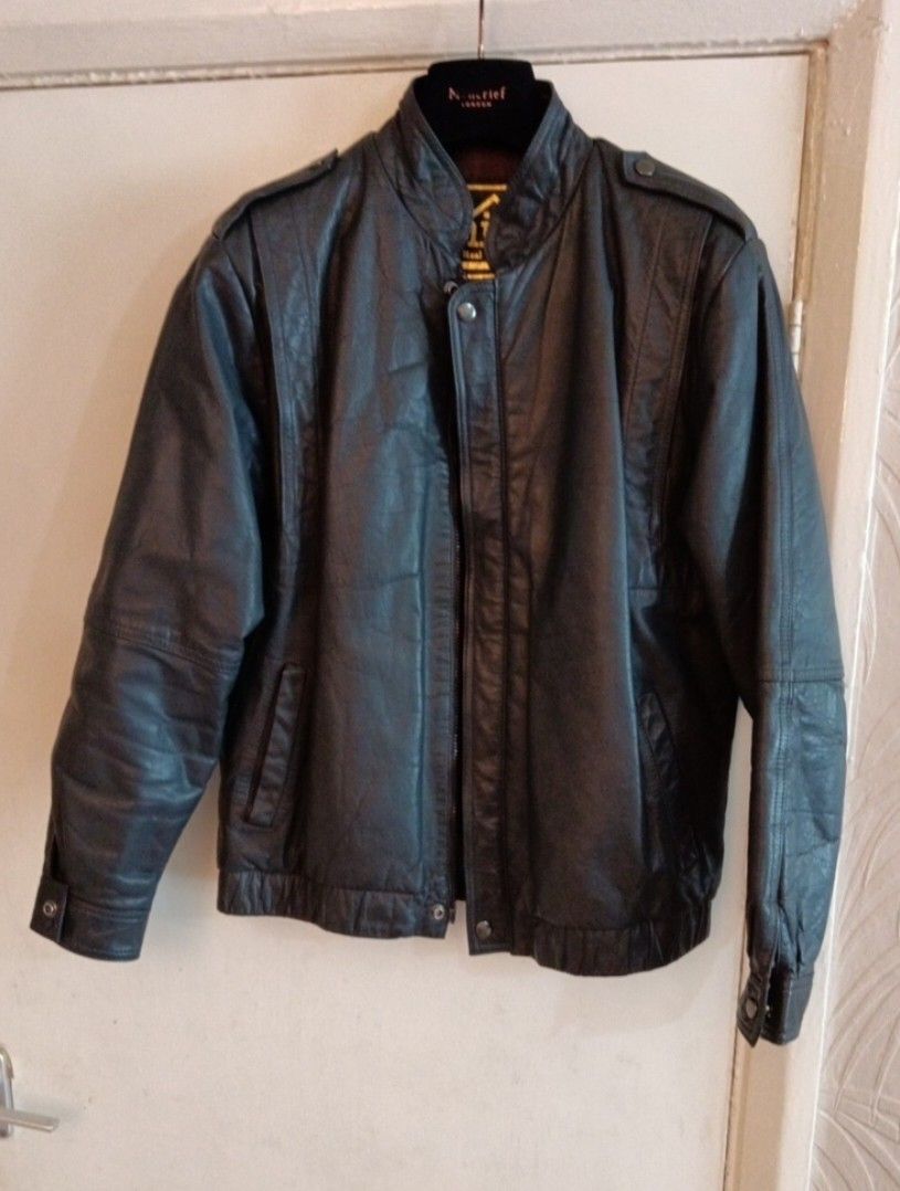 Black leather jacket bomber biker outerwear (Category: Coats, Jackets and Outerwear) located in Quezon City. Submitted by epoquebyjaz (Listing ID 1470617565, Image 1). Description: - Color: Black - Material: Leather - Closure: Front zip with snap button - Collar: Stand-up style - Cuffs & Hem: Ribbed for a snug fit - Pockets: Convenient slit pockets on both sides - Details: Shoulder epaulets included - Measurements: ~27 inches length, ~19 inches s