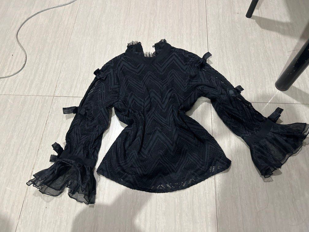 Black Long Sleeve Blouse with Ruffle Cuffs (Category: Longsleeves) located in Manila. Submitted by lovely.453 (Listing ID 1470678295, Image 1). Description: - Color: Black size small to medium - Pattern: All-over textured zigzag - Neckline: High neck with sheer ruffle details - Sleeves: Dramatic flared bell sleeves with cute ribbon accents - Fabric: Lightweight and sheer - Style: Ideal for gothic, romantic, or high-waisted pairings.