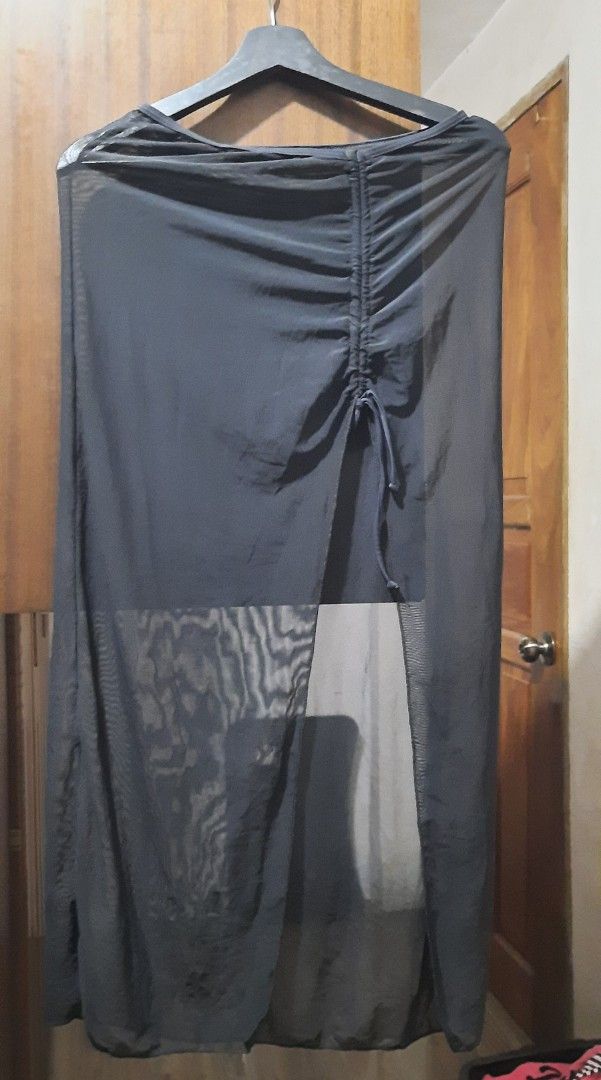 Black mesh maxi skirt with front slit and drawstring (Category: Skirts) located in Manila. Submitted by gracjam_27 (Listing ID 1470694266, Image 1). Description: - Color: Black - Material: Lightweight, see-through sheer mesh - Style: Maxi length skirt with adjustable front drawstring and high slit - Versatility: Perfect as a beach cover-up or trendy layering piece - Condition: Brand new / Excellent (ready to ship!).