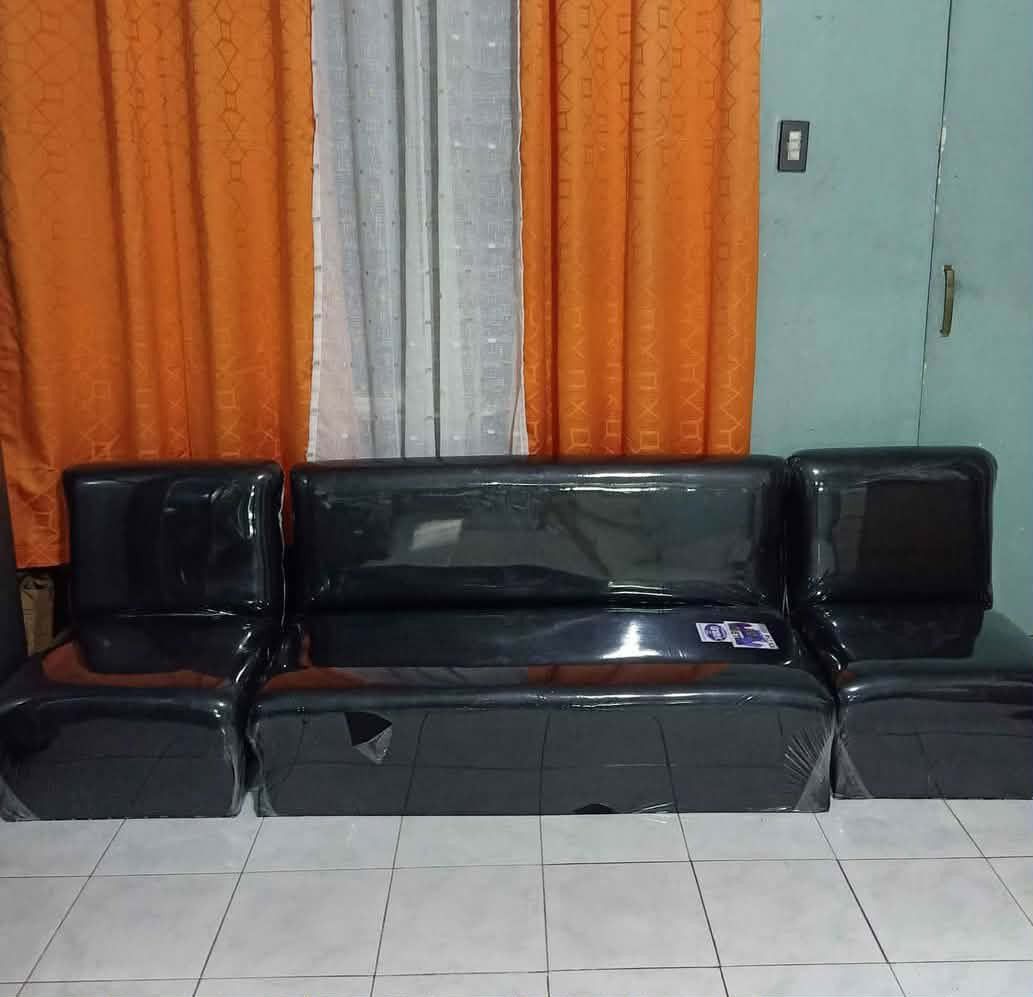 Black modular sectional sofa set with leather-like finish (Category: Sofas) located in Manila. Submitted by shawn0320_fish (Listing ID 1470675263, Image 3). Description: - Matching black sofa set: 1 long bench seat and 2 standalone side chairs - Material: Glossy synthetic leather, completely wrapped in protective plastic - Design: Modern dark finish with a sturdy build - Ideal for clean and stylish living room setups.
