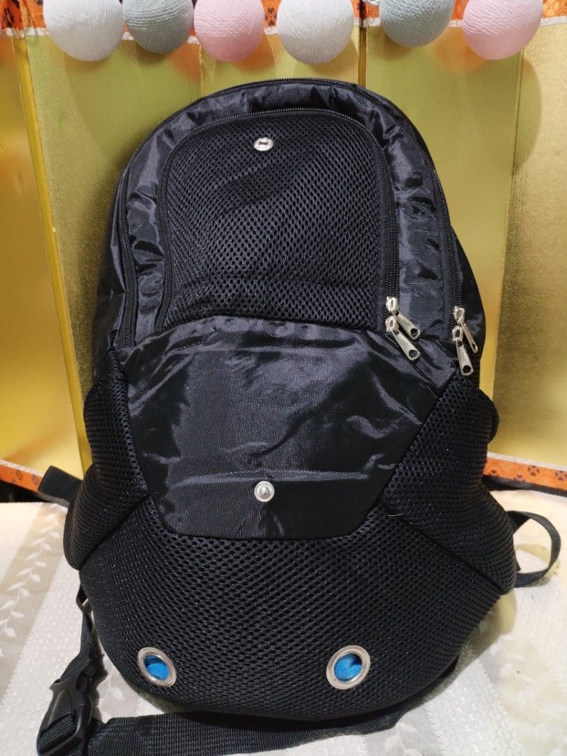 Black Pet Carrier Backpack with Mesh and Ventilation Holes (Category: Homes & Other Pet Accessories) located in La Trinidad. Submitted by malditas (Listing ID 1470706281, Image 2). Description: - Color: Sleek black - Dimensions: 17" H x 12.5" L x 6" W - Ideal for small cats and dogs - Front zippered opening with breathable mesh panel and snap button flap - Bottom ventilation eyelets for airflow - Convenient side mesh pockets for storage - Padded 