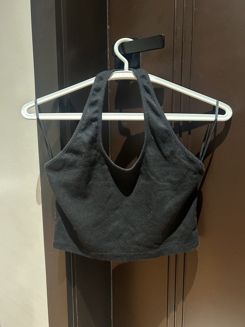 Black ribbed halter crop top (Category: Sleeveless) located in Davao. Submitted by lachisoo_ (Listing ID 1470712201, Image 1). Description: - Color: Black - Style: Halter crop top with deep V-neck and back straps - Fit: Cropped length, pairs well with high-waisted jeans or skirts - Material: Soft, stretchy ribbed knit fabric - Condition: Worn a few times, washed and stored properly.